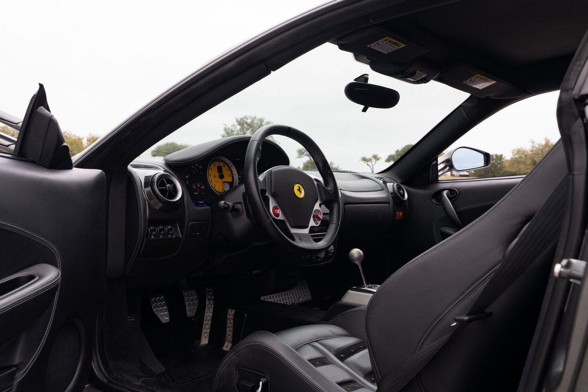 Black leather interior of a 2007 Ferrari F430 6-speed, Grigio Silverstone exterior.