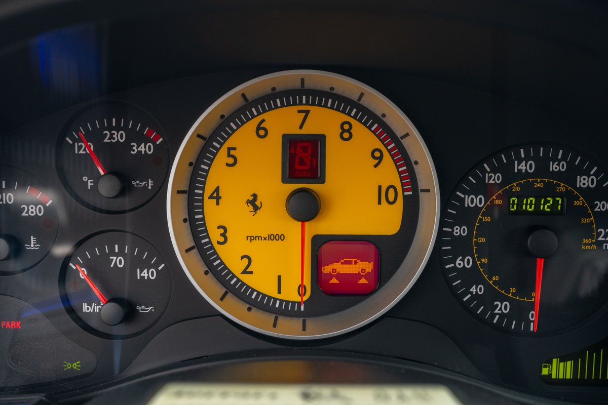 2007 Ferrari F430 6-speed dashboard with yellow-faced tachometer and speedometer.