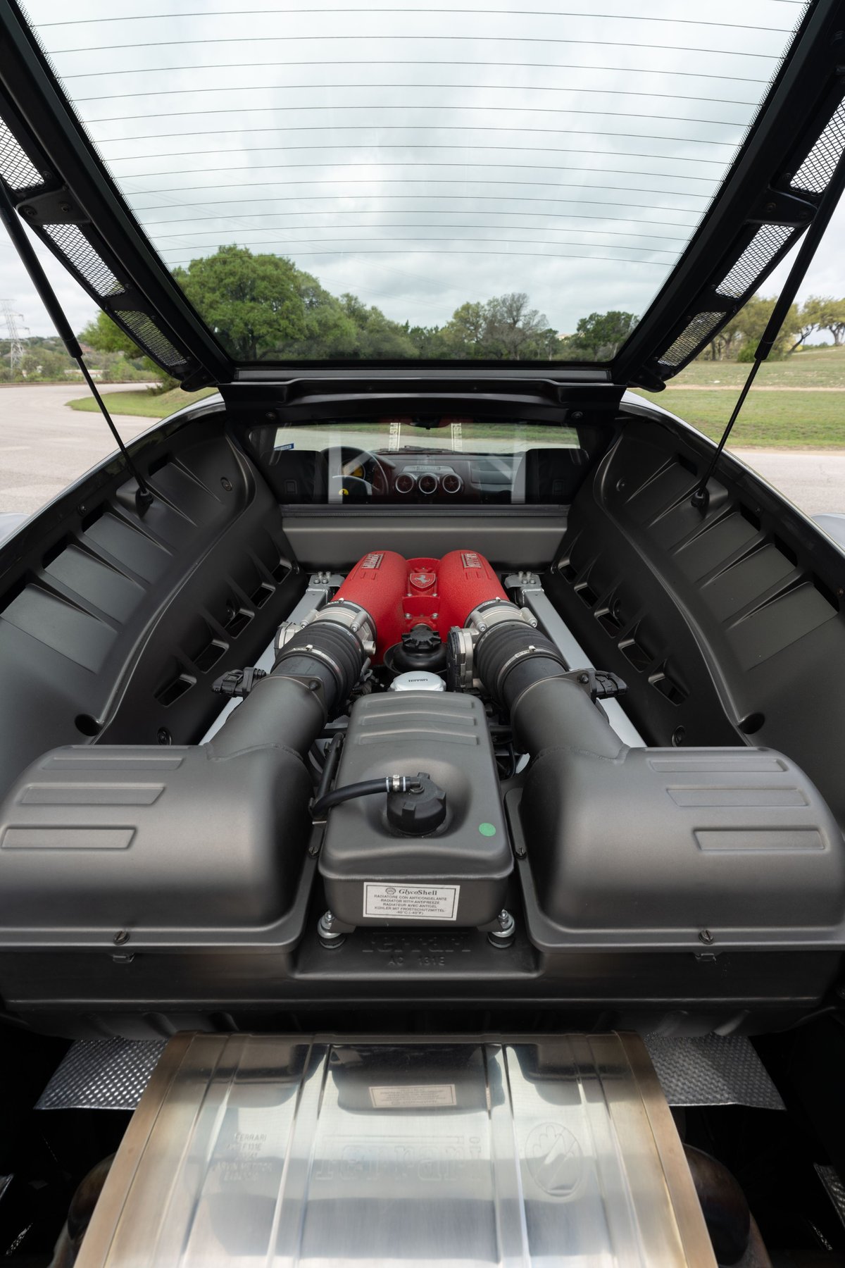 2007 Ferrari F430 6-speed engine bay. Grigio Silverstone paint. V8 engine with red intake manifolds.