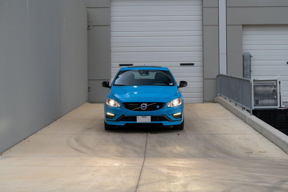Front view of a Rebel Blue 2015 Volvo V60 Polestar on a concrete ramp.