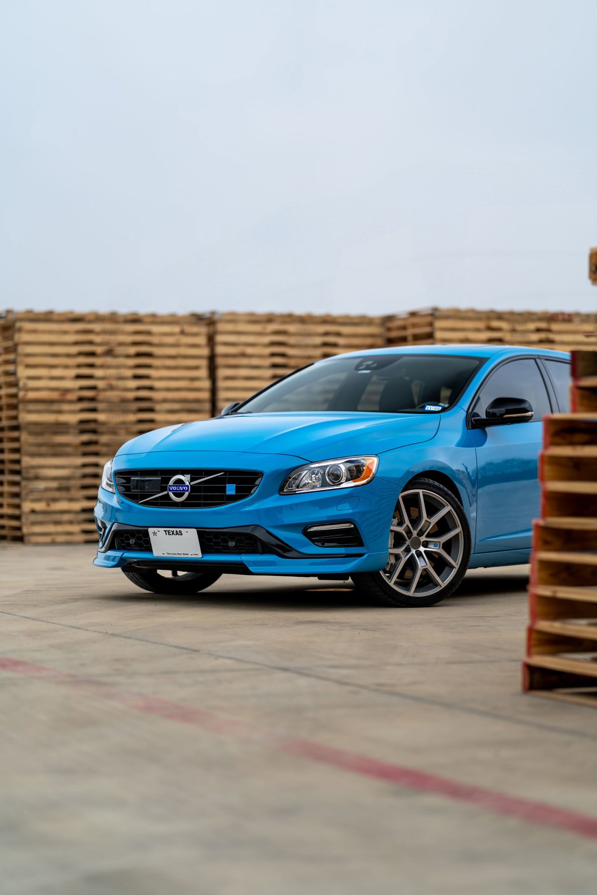 Rebel blue 2015 Volvo V60 Polestar with silver multi-spoke rims and black trim.