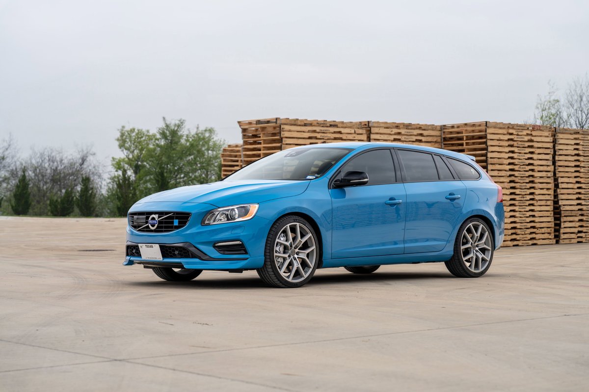 A rebel blue 2015 Volvo V60 Polestar wagon with multi-spoke silver rims and black trim.