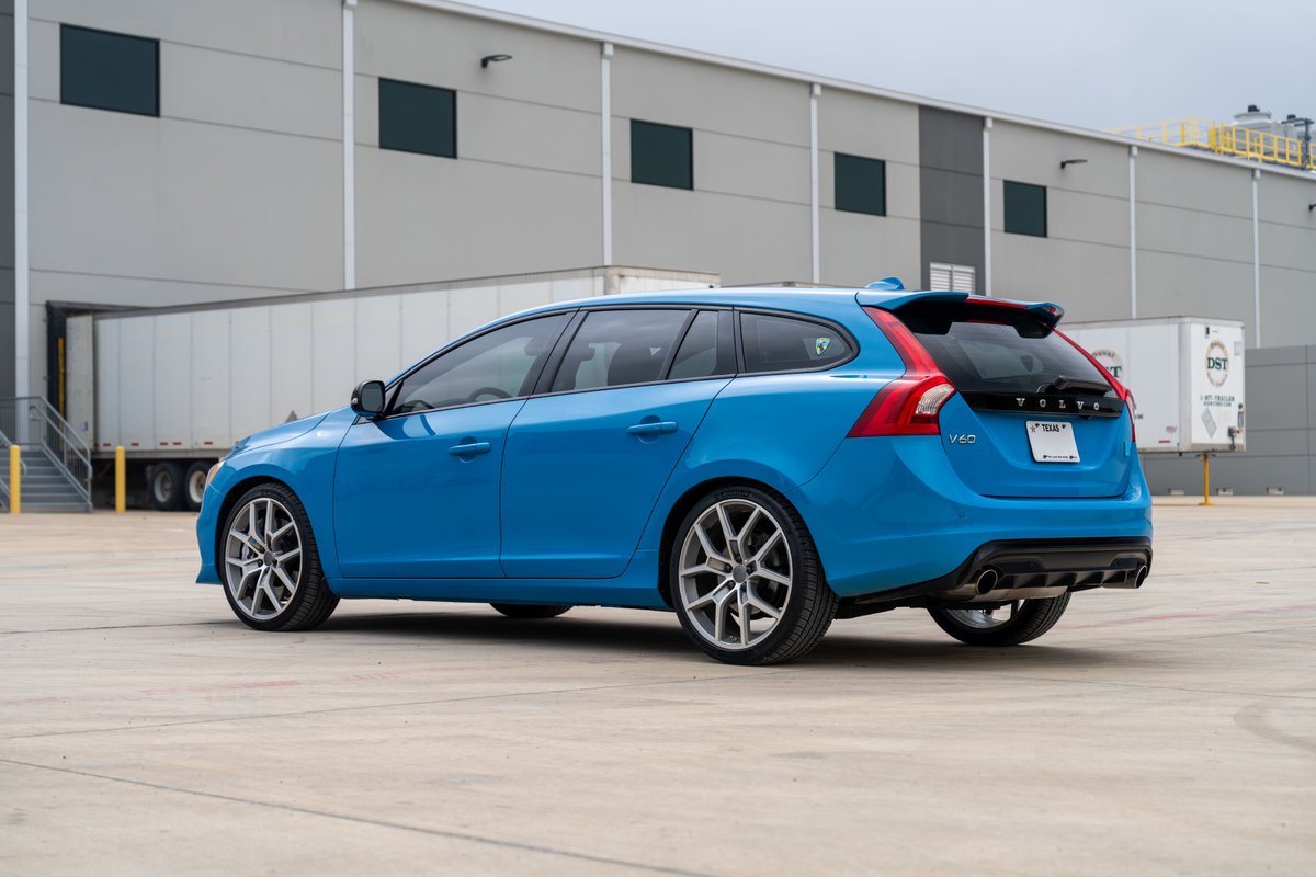 Rebel Blue 2015 Volvo V60 Polestar wagon with multi-spoke silver rims and sport trim.