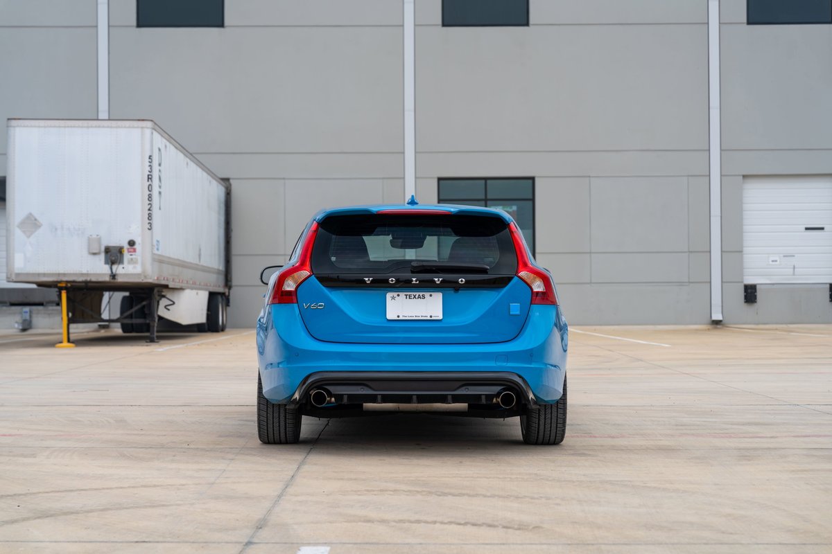 Rear view of a Rebel Blue 2015 Volvo V60 Polestar, showcasing its dual exhaust and sporty trim.