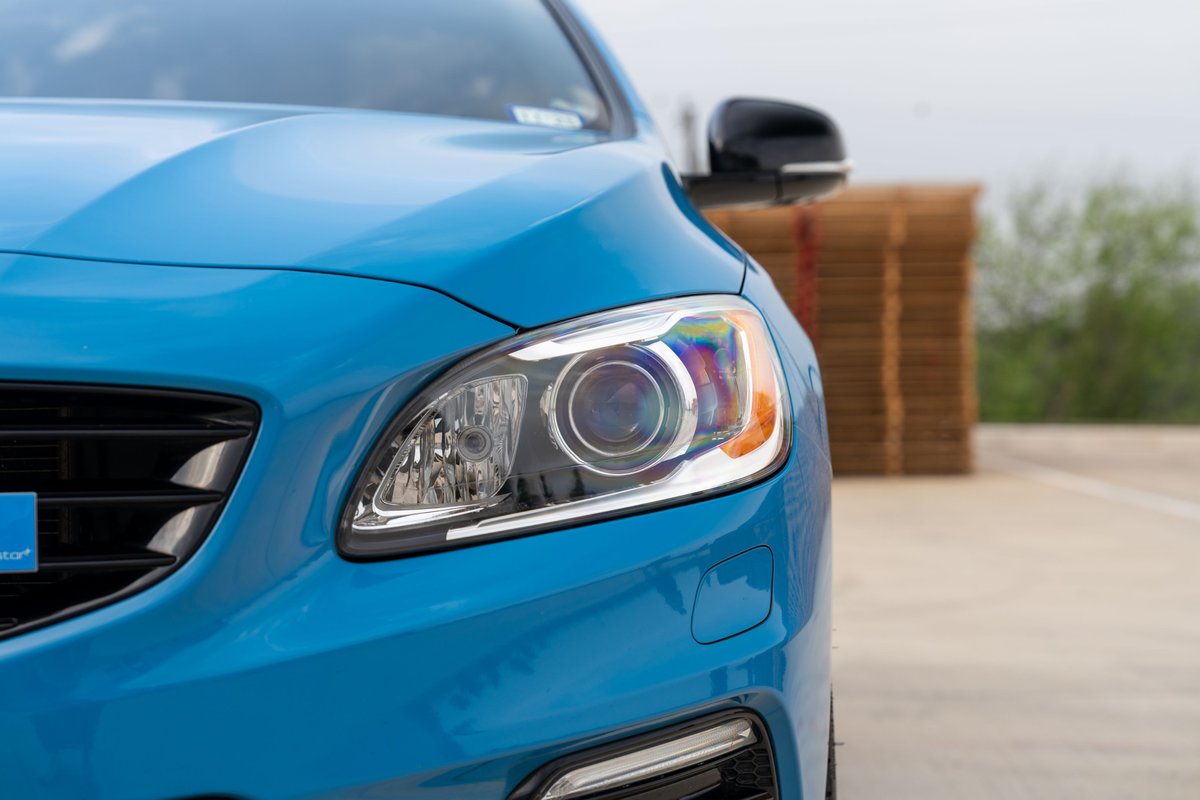 Close up of a Rebel Blue 2015 Volvo V60 Polestar's LED headlight and grille.