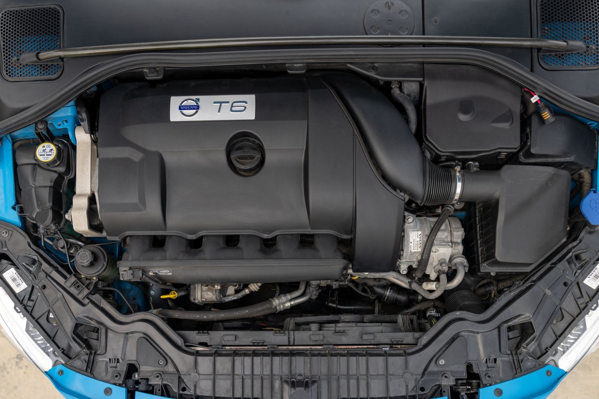 Engine bay of a 2015 Volvo V60 Polestar in Rebel Blue, featuring the T6 engine cover.