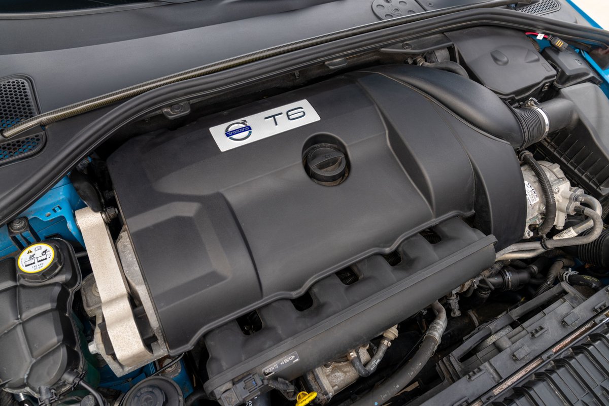 Close-up of a Volvo T6 engine, featuring the iconic T6 badge on the black engine cover in a 2015 V60 Polestar.