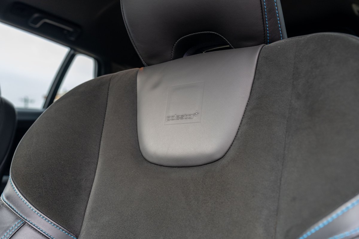 2015 Volvo V60 Polestar, gray suede sport seat with embossed logo and blue stitching.