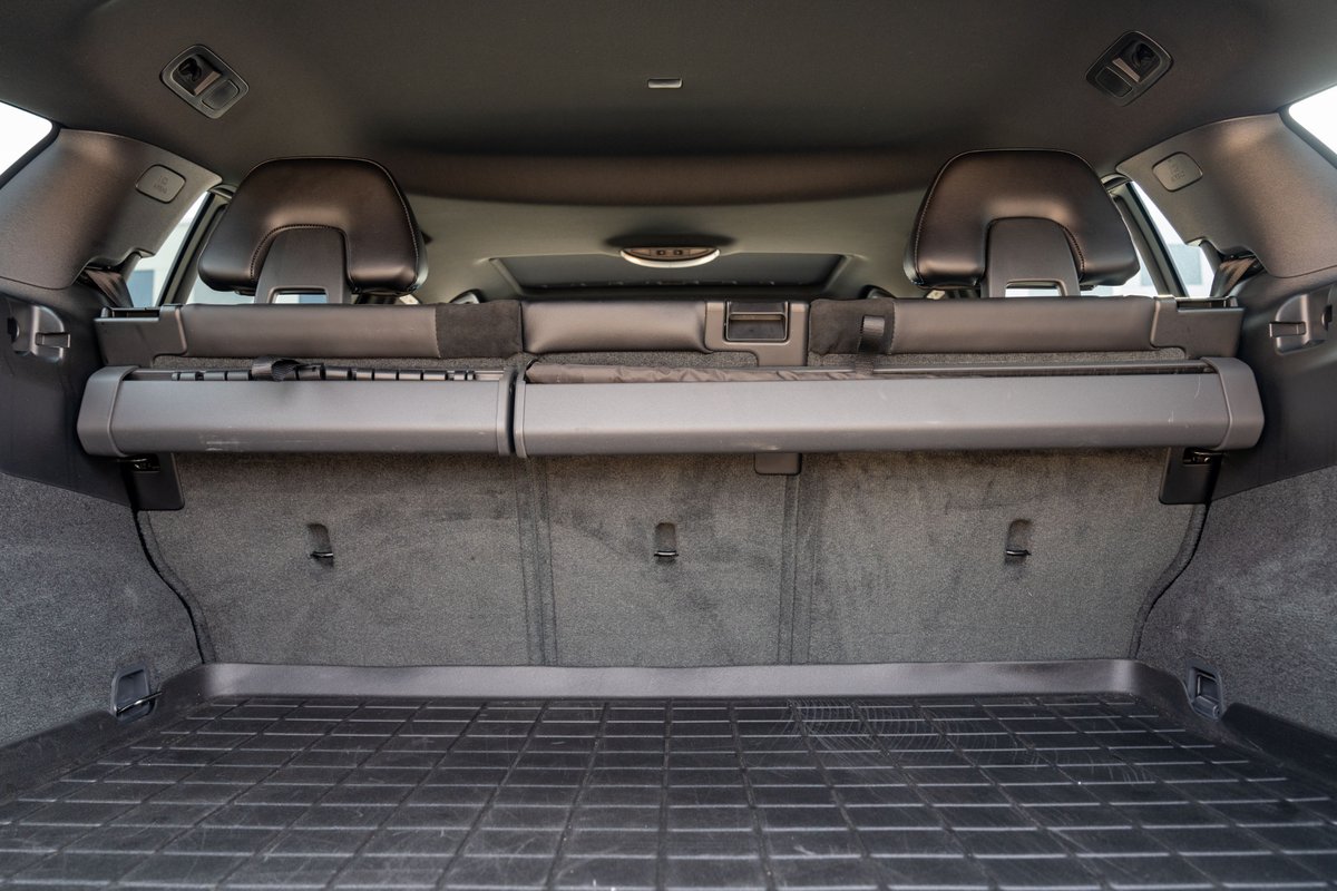 2015 Volvo V60 Polestar cargo area with retractable tonneau cover and rubber floor mat.