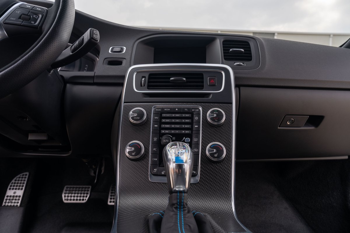 2015 Volvo V60 Polestar center console with carbon fiber trim and blue accents.
