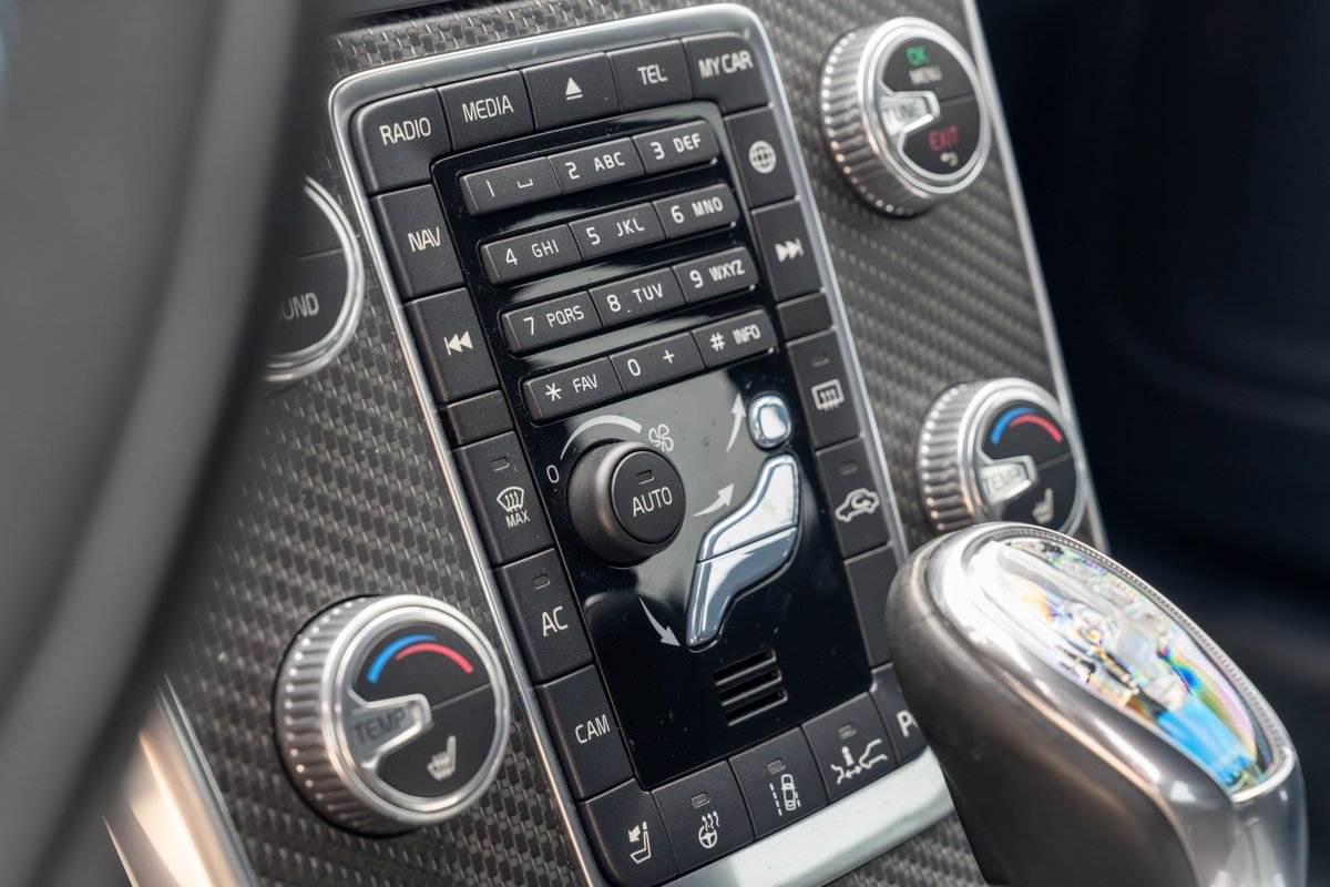 Close-up of the carbon fiber interior trim and climate controls on a 2015 Volvo V60 Polestar.
