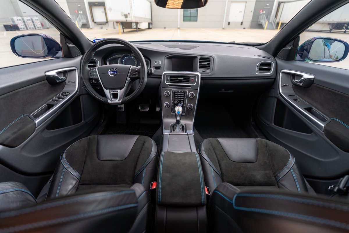 2015 Volvo V60 Polestar interior in Rebel Blue with Alcantara trim and blue stitching on seats.