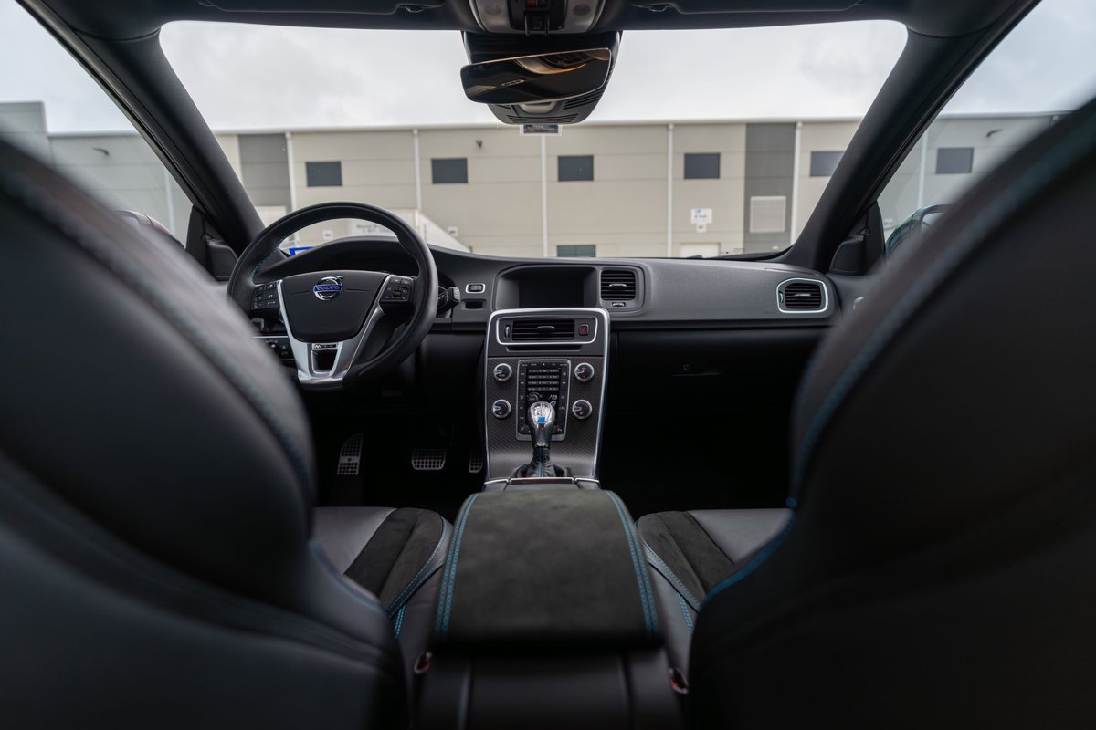 2015 Volvo V60 Polestar interior in Rebel Blue. Black sport seats with blue stitching, leather trim.