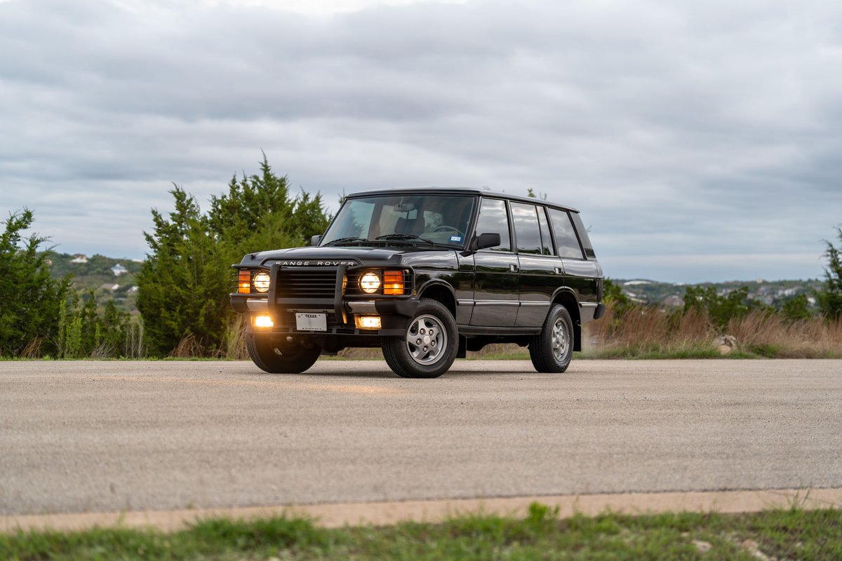 1994 Land Rover Range Rover County LWB in black, featuring classic quad headlights and 5-spoke rims.