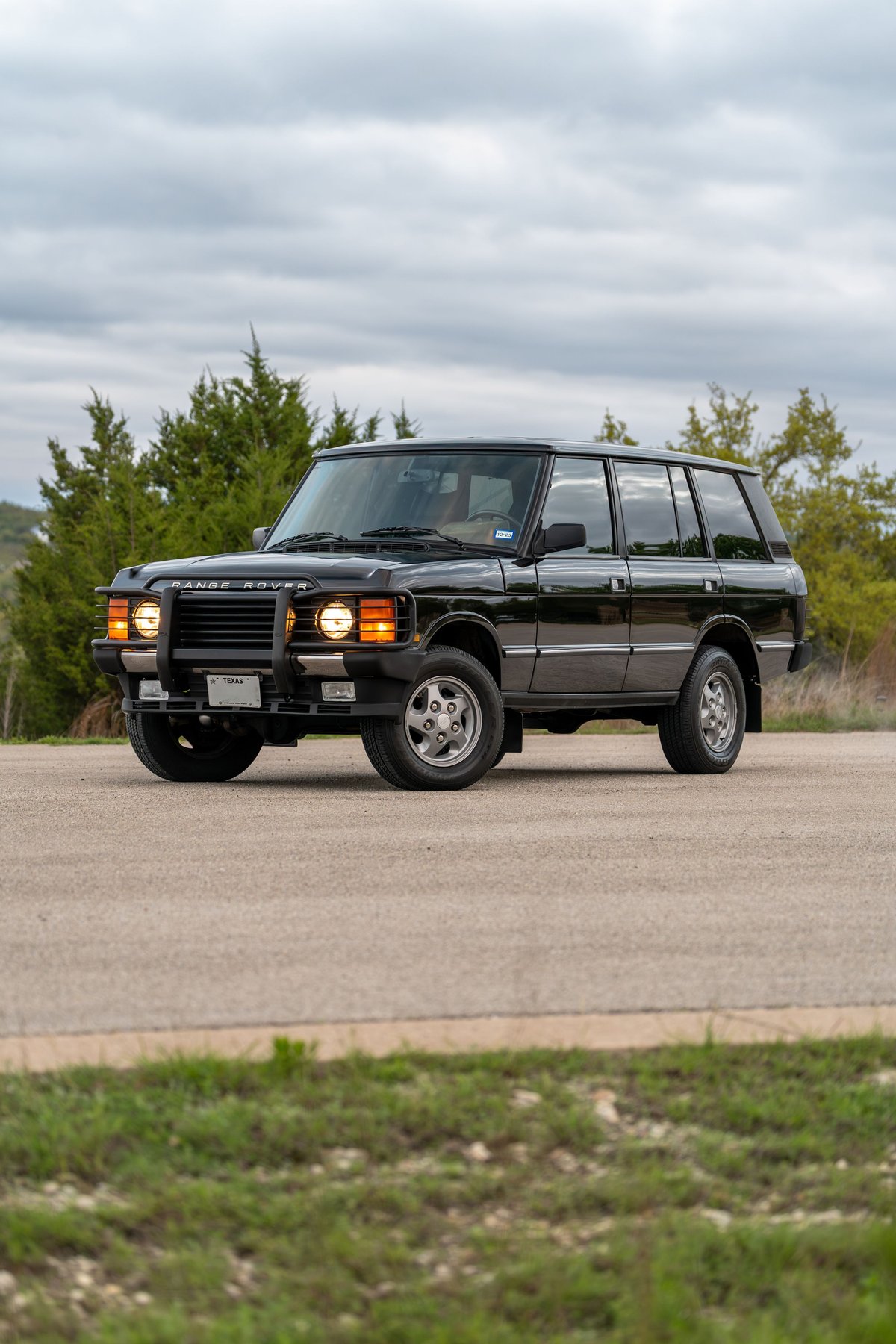 Black 1994 Range Rover County LWB SUV with five-spoke rims and chrome trim.