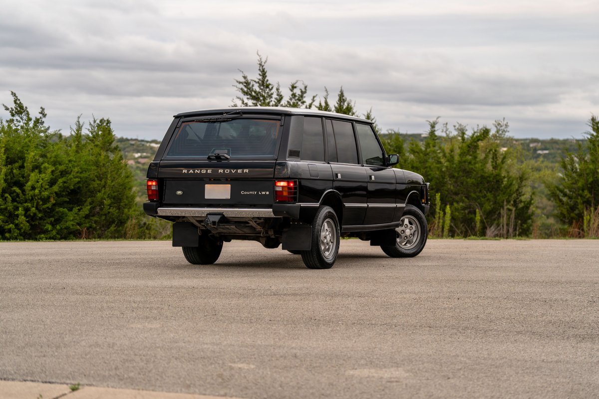 1994 black Land Rover Range Rover County LWB rear quarter view with chrome rims.