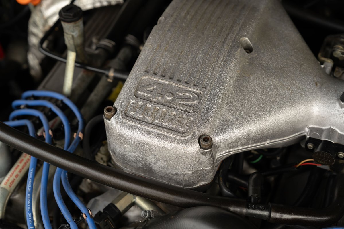 Close-up of a 1994 Range Rover County LWB engine with a "4.2" badge on the intake manifold.