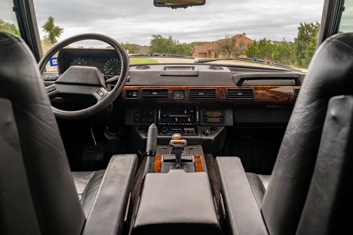 1994 Range Rover County LWB interior, featuring wood trim, leather seats, and automatic gear shifter.