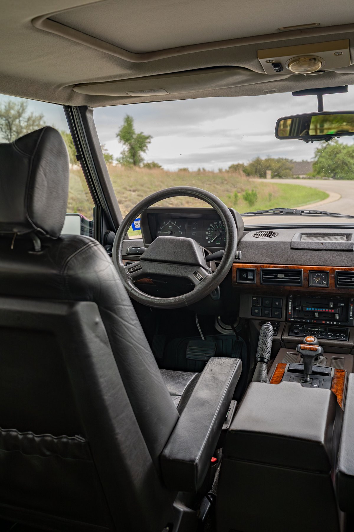 Interior of a 1994 Land Rover Range Rover County LWB with wood trim and leather seats.