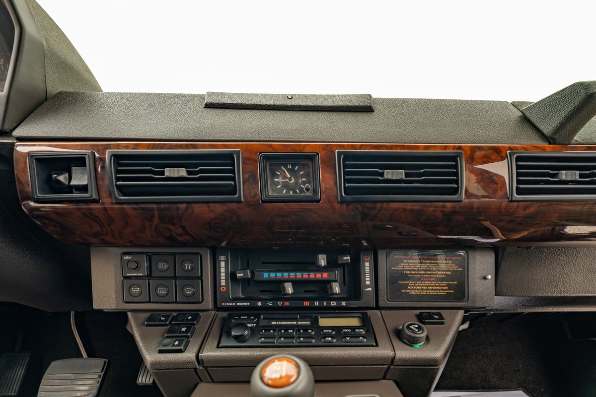 1994 Land Rover Range Rover County LWB interior, wood trim dashboard, center console with analog clock.