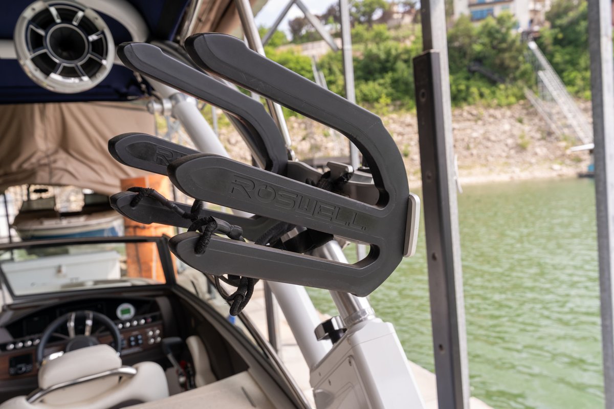 A gray surfboard rack on a Cobalt R7 Surf boat, mounted to the tower.