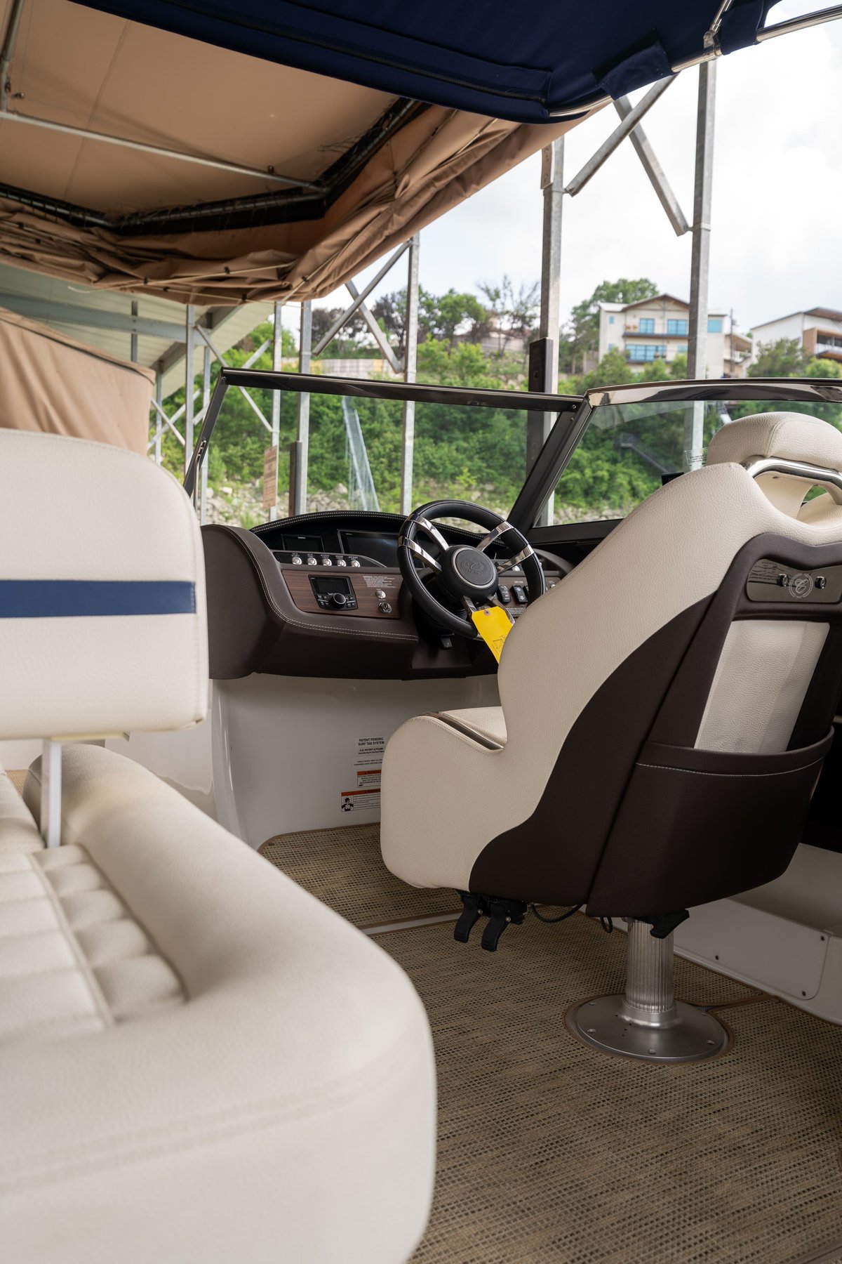 Cobalt R7 Surf boat interior with two-tone captain's chairs, wood trim, and a digital dash.