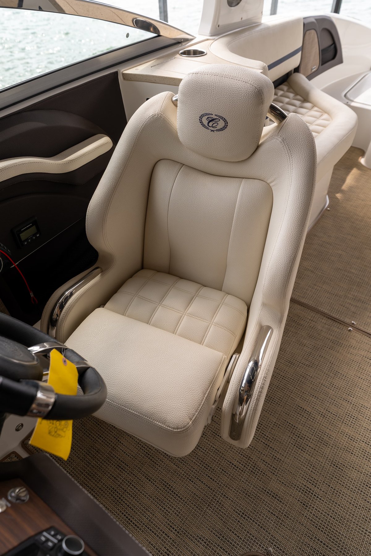 Cream leather captain's chair with quilted seat and chrome trim in a 2018 Cobalt R7 Surf boat.