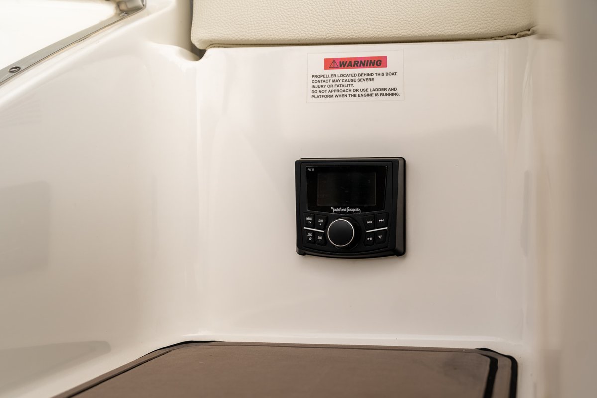2025 Cobalt R7 Surf boat with Rockford Fosgate stereo and warning sticker.