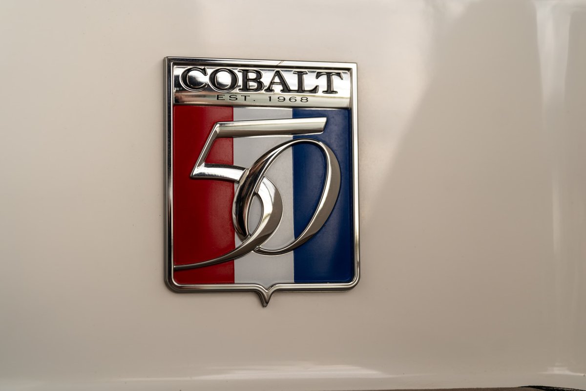 Close-up of a white 2018 Cobalt R7 Surf Boat emblem with "50 EST. 1968" text.