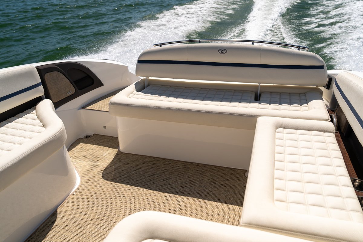 White Cobalt R7 Surf boat interior with upholstered seating and blue trim.