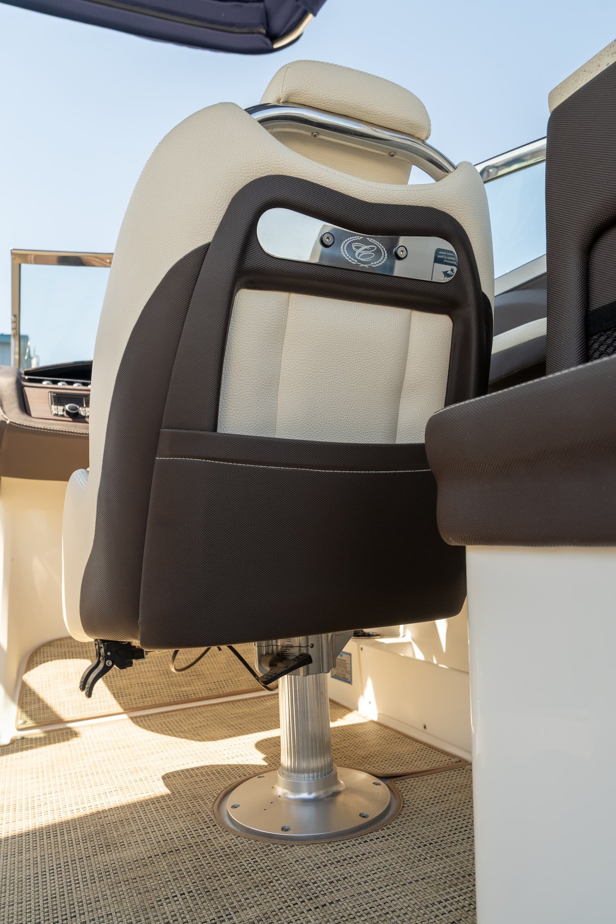 Cobalt R7 Surf boat helm seat with two-tone upholstery and polished metal base.