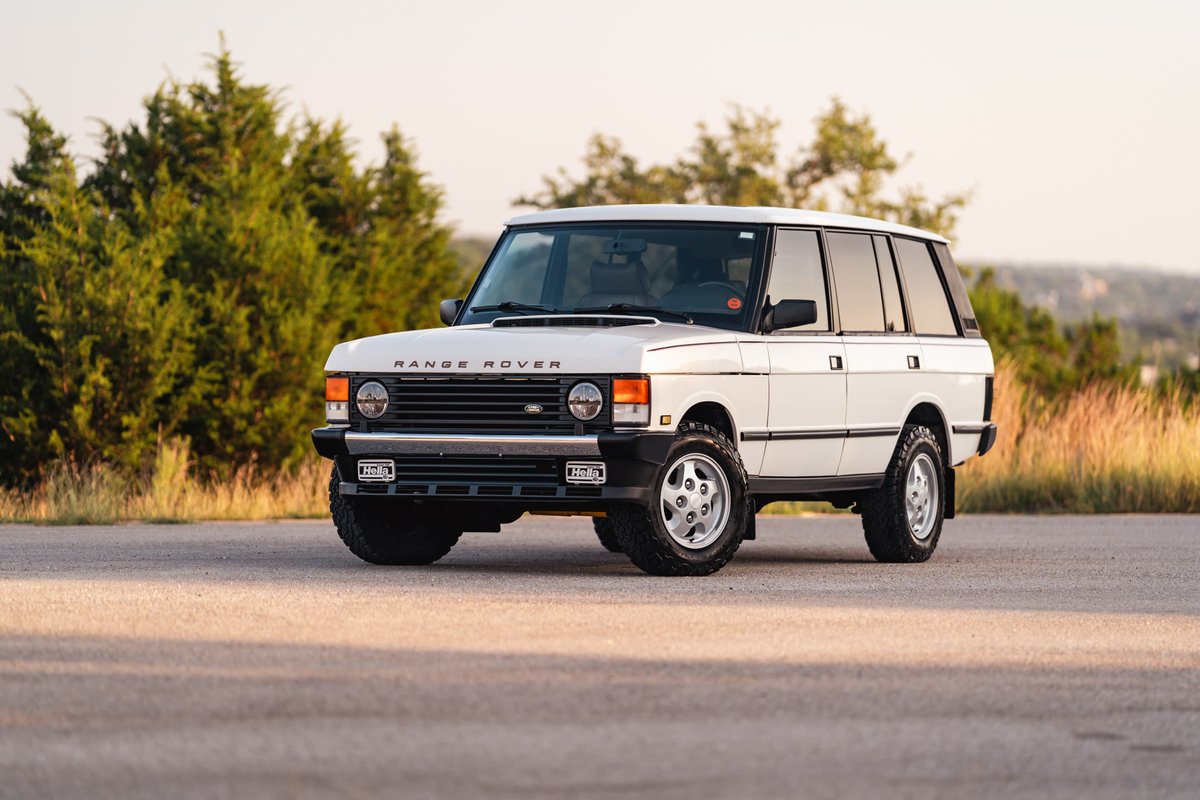 White 1995 Land Rover Range Rover County with chrome rims.