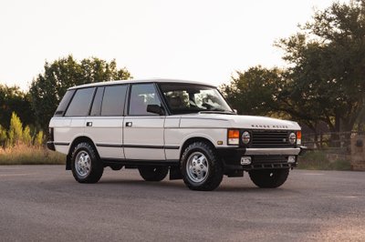 White 1995 Land Rover Range Rover County Classic with chrome trim and alloy rims.