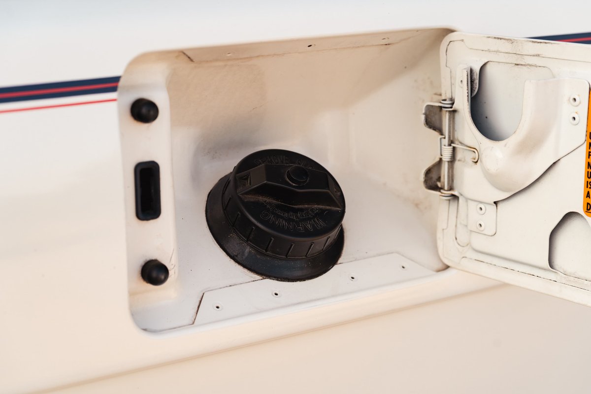 1995 Land Rover Range Rover County white fuel filler door with black cap and red/blue trim.