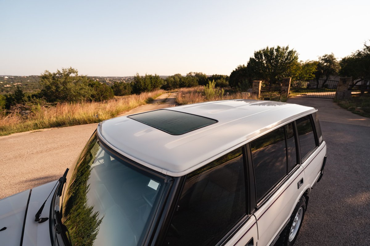 White 1995 Land Rover Range Rover County with a sunroof.