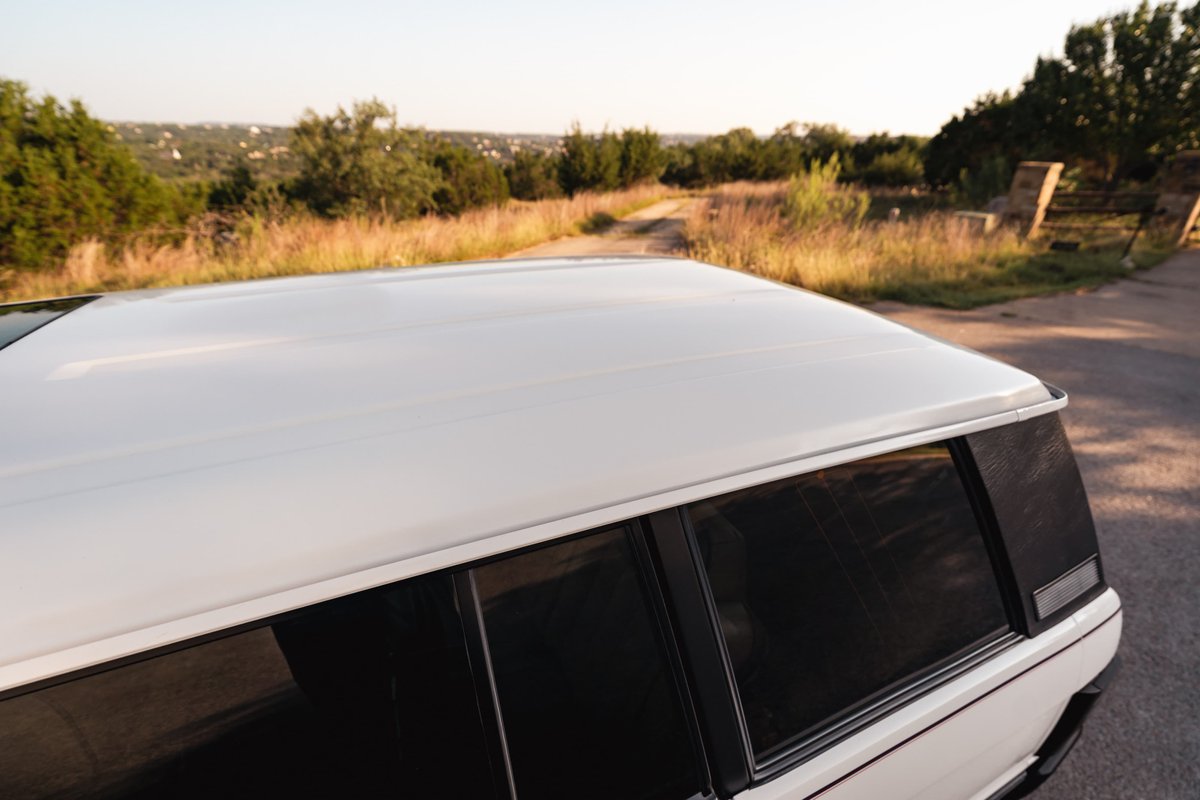 White 1995 Land Rover Range Rover County roof and rear window trim detail.