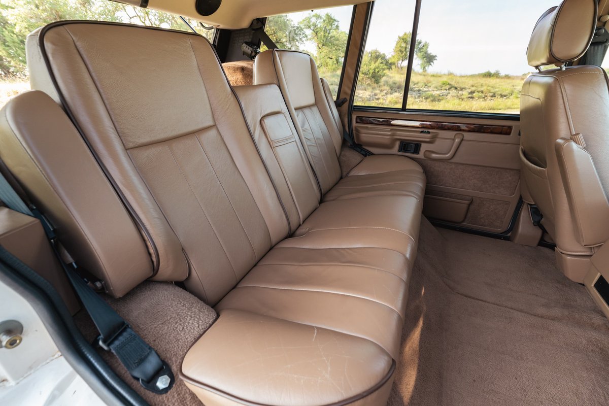 1995 Range Rover County interior: tan leather rear seats, wood trim, tan carpet.