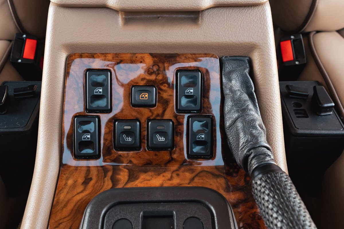 1995 Land Rover Range Rover County interior: wood trim, window and heated seat controls, leather gear shifter.