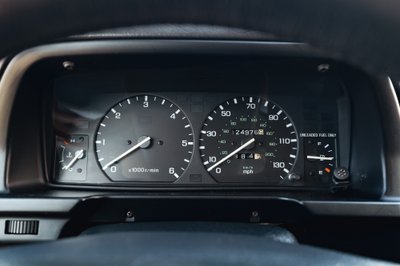 1995 white Land Rover Range Rover County dashboard, with tachometer and speedometer.