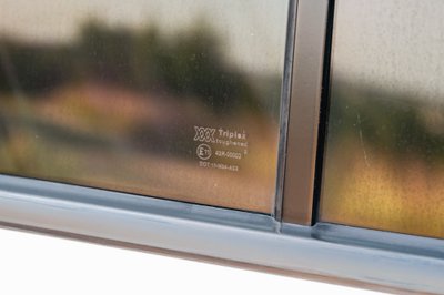 1995 white Range Rover County side window with Triplex toughened glass marking.