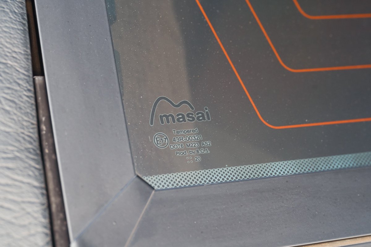Close up of the Masai branded, tempered rear window of a white 1995 Land Rover Range Rover County.