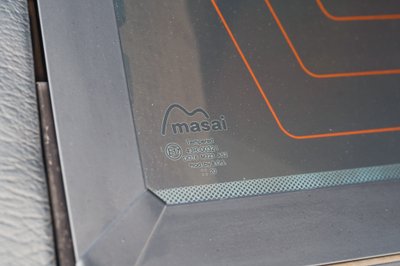 Close up of the Masai branded, tempered rear window of a white 1995 Land Rover Range Rover County.
