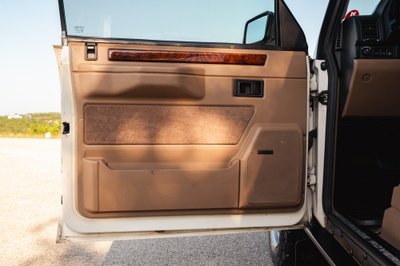1995 Range Rover County interior door panel with wood trim and Bose speaker.