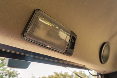 Interior dome light with ON/OFF switch on a 1995 white Land Rover Range Rover County.