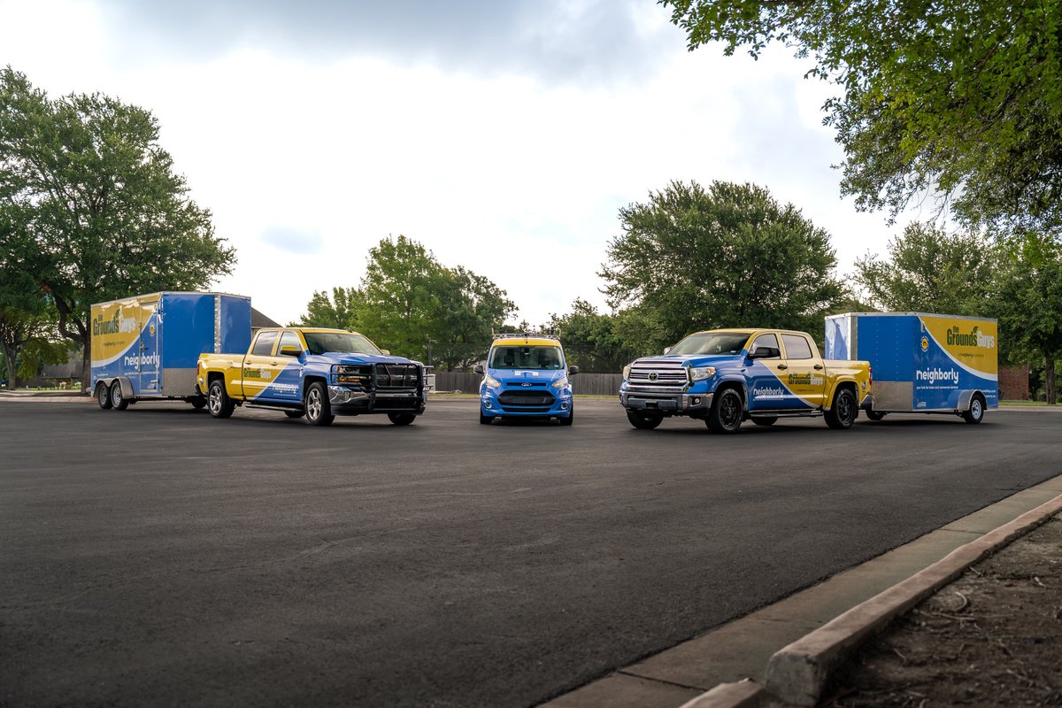 Two Chevrolet Silverado pickup trucks and a blue van with custom yellow and blue livery.