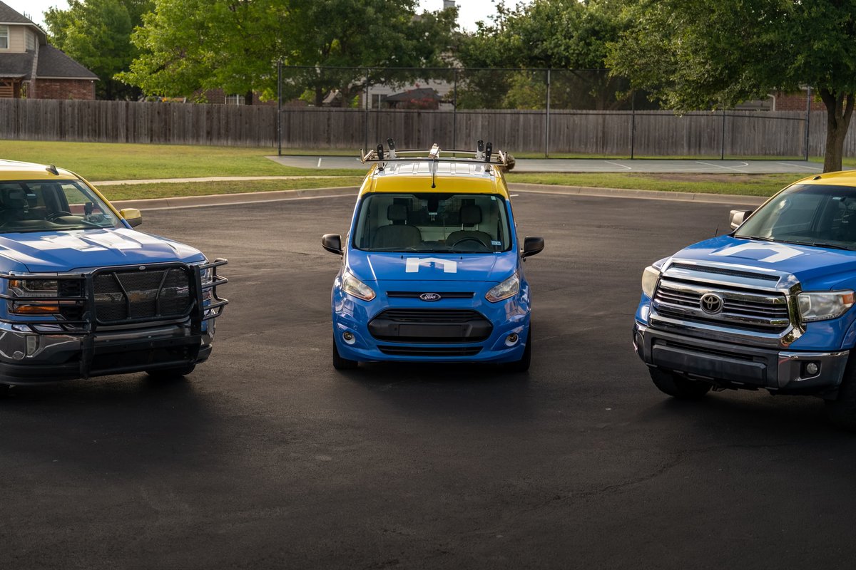 Blue Ford Transit Connect van with yellow roof, custom livery, and roof rack.