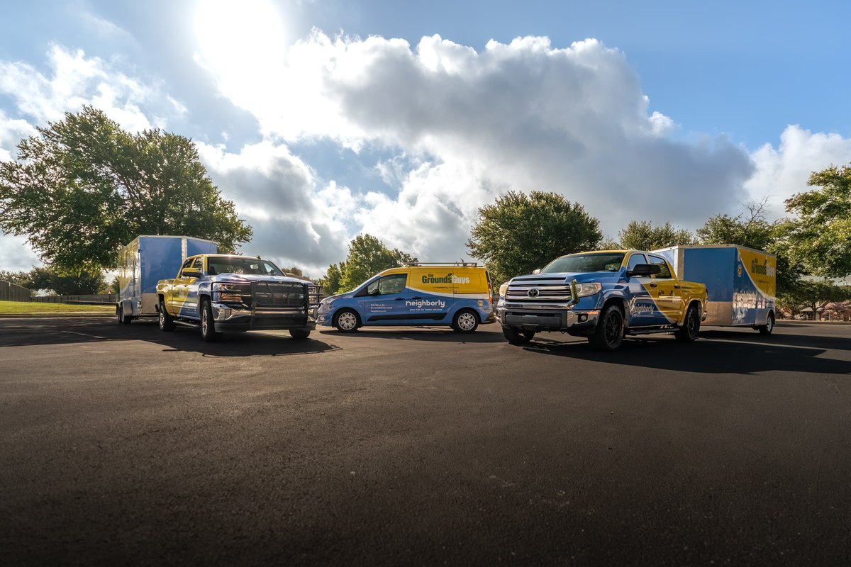 Two blue & yellow Trucks towing trailers, a blue van with livery. Trucks have unique livery.