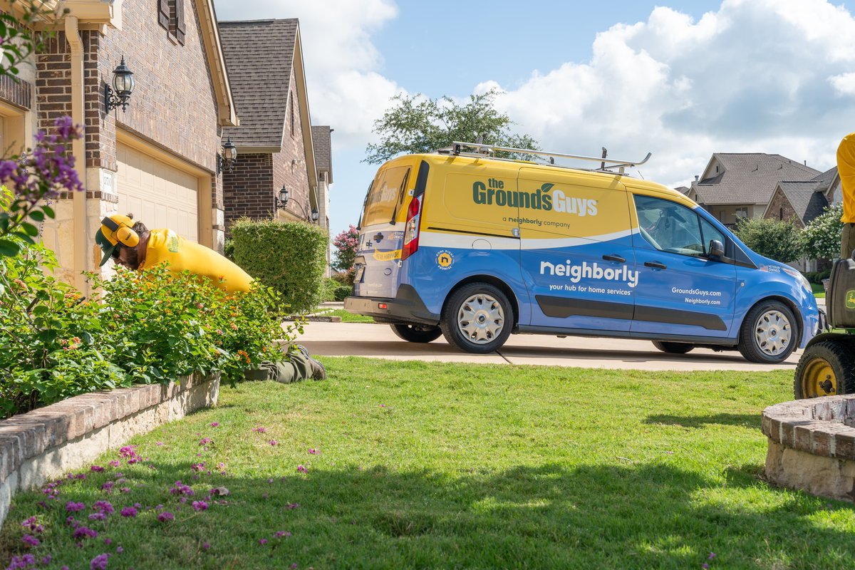 Ford Transit van with Ground's Guys livery, parked in a suburban driveway.