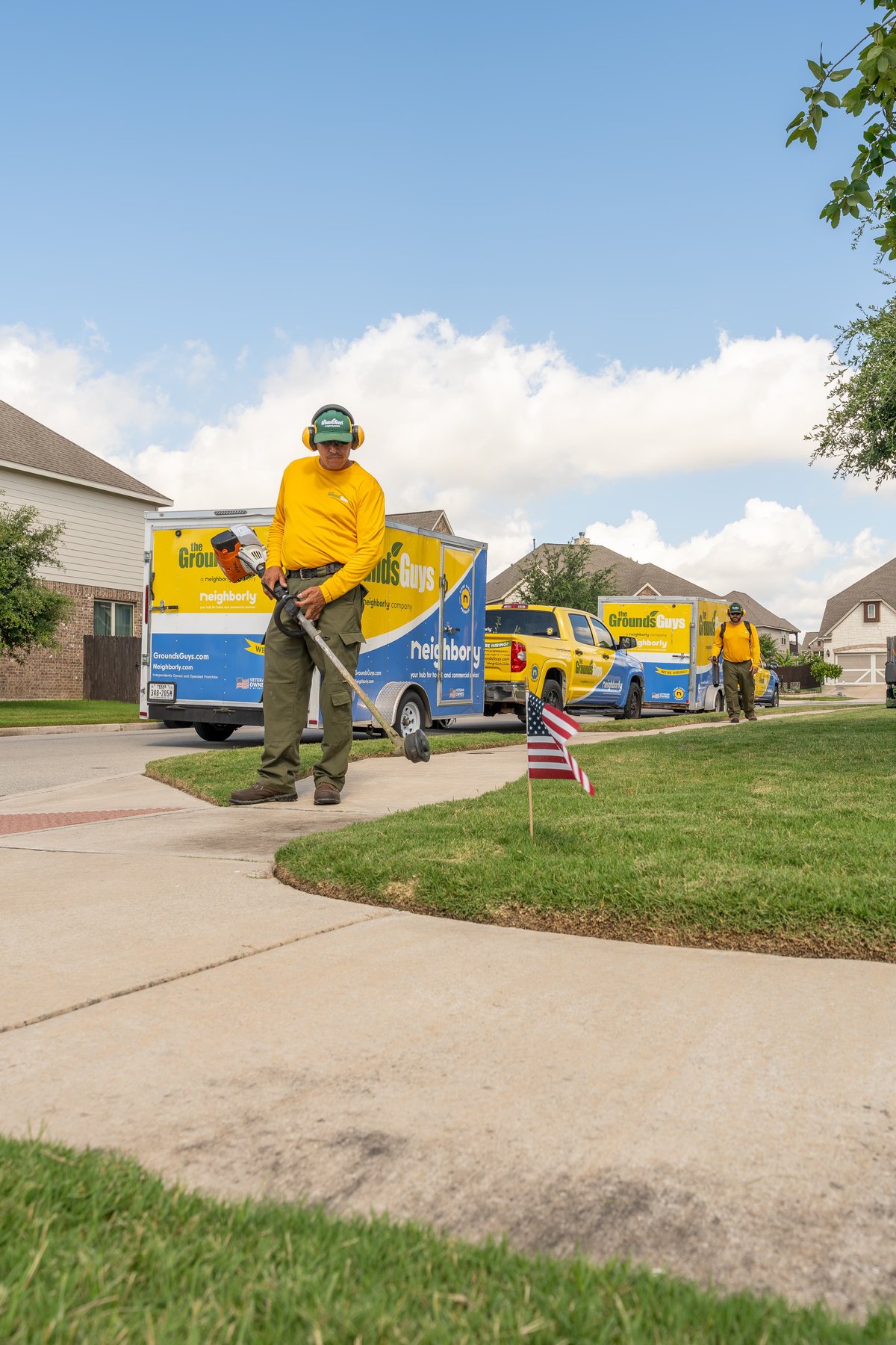 Grounds Guys Ford F-150 truck in yellow with blue livery trim.