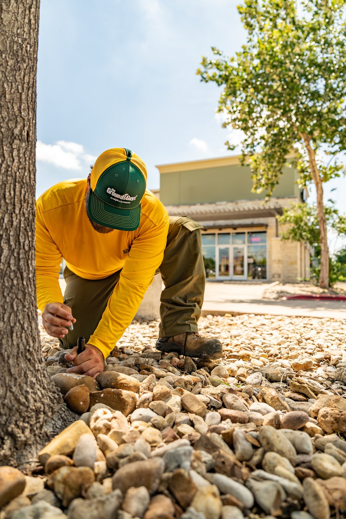 I'm sorry, but there is no vehicle visible in this image. The photo shows a person working in landscaping.